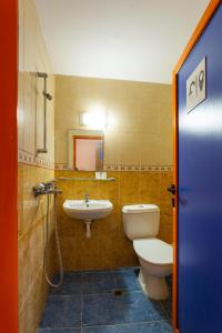 a bathroom with a toilet and a sink at Family Hotel Jemelly in Obzor