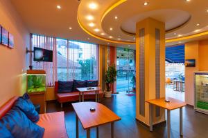 a lobby with a fish tank in a building at Family Hotel Jemelly in Obzor