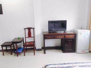 una habitación con un escritorio con televisión y una silla en Khách sạn Mai Lan, en Ho Chi Minh
