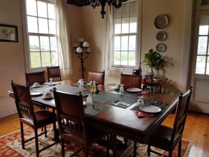 a dining room with a wooden table and chairs at Quinta do Fôjo in Lamego