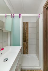 a white bathroom with a shower and a sink at Nono Mario in Piran