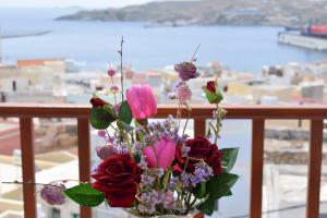 a vase filled with flowers on top of a dock at Diana in Ermoupoli
