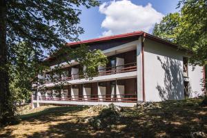 a building on a hill with trees at Hotel Bellevue in Plitvička Jezera +16 photos