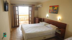 a bedroom with a large bed and a window at Beachhotel Morro do Careca in Natal +23 photos