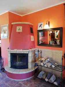 a living room with a fireplace and a mirror at Lisi Dwór in Czarny Młyn +21 photos