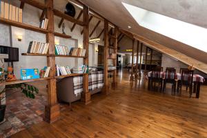 a large room with wooden floors and wooden beams at Korali in Yaremche