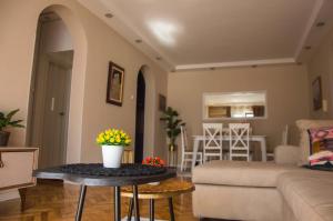 a living room with a couch and a table with flowers on it at Ana's Place in Kotor