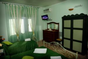 a bedroom with two beds and a mirror at Maison De Lussy in Piazza Armerina