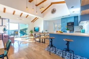 an open kitchen and dining room with blue cabinets at Lucy in Omiš