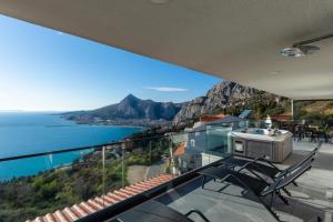 a view of the ocean from the balcony of a house at Lucy in Omiš
