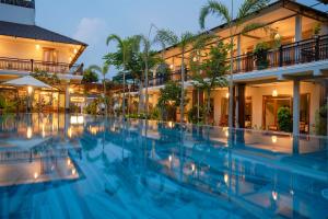 a hotel swimming pool in front of a building at Suối Mây Phú Quốc Garden Resort - Full 24h Stay in Phu Quoc