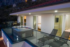 a house with a glass roof with a swimming pool at Lucy in Omiš