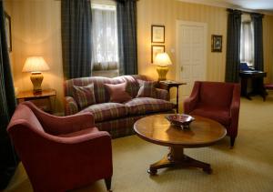 
a living room filled with furniture and a couch at Inverlochy Castle Hotel in Fort William
