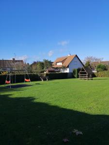 a large grassy yard with a soccer field with at Ryo Beach in Courseulles-sur-Mer