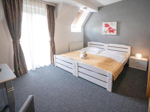 a bedroom with a white bed and a window at Apartments City Centre in Bratislava