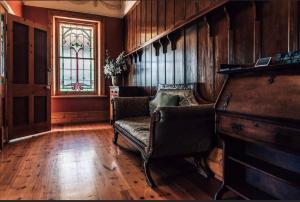 a living room with a couch and a stained glass window at Barossa Dreams in Tanunda