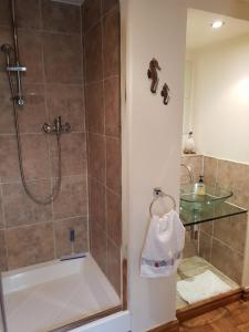 a bathroom with a shower and a bath tub at The Coach House Holiday Cottage, Southport in Southport +43 photos