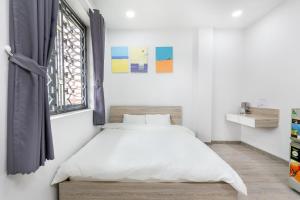 Postel nebo postele na pokoji v ubytování Dlux Saigon