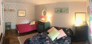 a bedroom with a bed and a table and a mirror at Le Châtel in Riec-sur-Bélon +19 photos