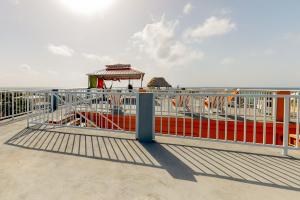 a metal railing on a beach with a gazebo at Laguna Suites in San Pedro