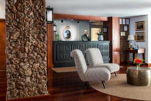 two chairs in a living room with a mirror at Parador de El Hierro in Las Casas