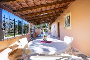 a dining room with a table and chairs on a balcony at Taxiarchis Home in Kounoupidhianá