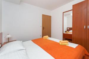 Postel nebo postele na pokoji v ubytování Apartments Ricina