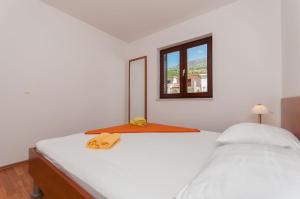 Postel nebo postele na pokoji v ubytování Apartments Ricina