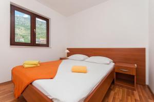 Postel nebo postele na pokoji v ubytování Apartments Ricina