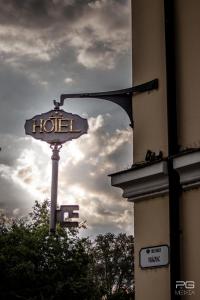 a sign for a hotel on the side of a building at Hotel Klastrom in Győr