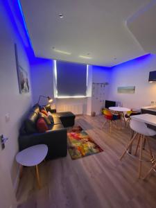 a living room with a couch and chairs and tables at Ayr Riverside Apartments in Ayr