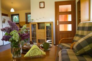 a living room with a vase of flowers on a table at Zielony domek in Bielsko-Biała