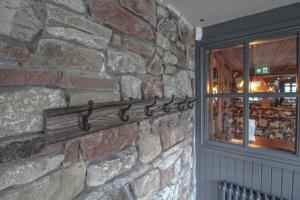 a stone wall with a metal towel rack on a wall at The Pooley Bridge Inn in Pooley Bridge