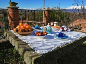 a table with a bowl of fruit on top of it at Le Viole Bianche in Albiano dʼIvrea +19 photos
