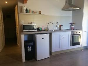 a kitchen with a sink and a microwave on a counter at Clos Olivella in Monticello