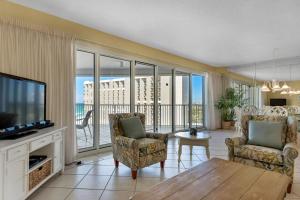 a living room with a television and a couch and chairs at TOPS'L Tides II in Destin