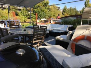 a patio with a table and some chairs and a table and chairsktop at Boat For Guest in Issy-les-Moulineaux