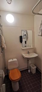 a bathroom with a toilet and a sink at Sundsvall City Hotel in Sundsvall