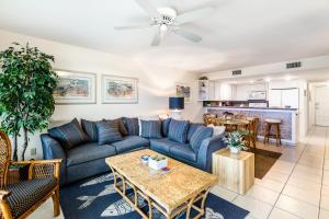 a living room with a blue couch and a table at Saida Tower I in South Padre Island