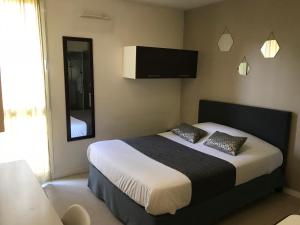 a bedroom with a bed with a television on the wall at Neoresid - R&eacute;sidence Lille-Lambret in Lille