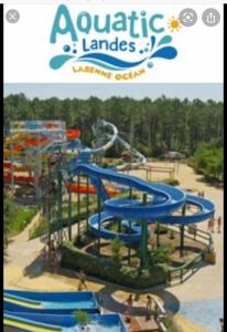 a water park with a blue water slide at Maison bord mer in Labenne