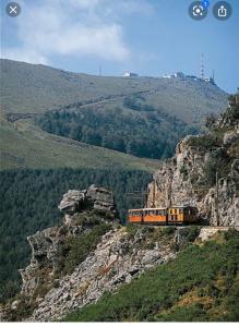 a train is traveling on a rocky mountain at Maison bord mer in Labenne