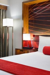 a bedroom with a large bed with two lamps at Crowne Plaza JFK Airport New York City, an IHG Hotel in Queens