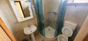 a bathroom with a shower and a toilet and a sink at LA CANAPELE ROCK in Vama Veche +27 photos