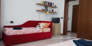 a red couch with a dog laying on it in a room at Appartamento Alla Corte in Venice