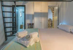 a bedroom with a bed with towels on it at Komia Sea View Traditional in Komia