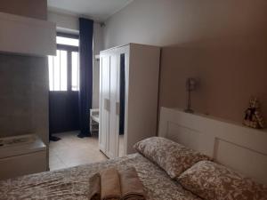 1 dormitorio con 1 cama y armario blanco en Al campanile, en Frosinone