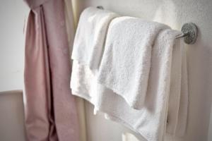 a group of towels hanging on a towel rack in a bathroom at Witchingham B&B in Holyhead