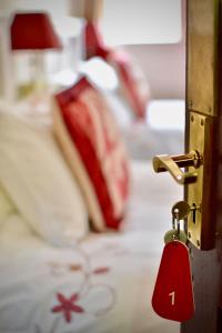 a padlock on a door with a bed at Witchingham B&B in Holyhead