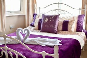 a bedroom with a bed with two hearts on it at Witchingham B&B in Holyhead